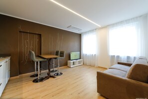 Deluxe Apartment, City View | Living area | Flat-screen TV