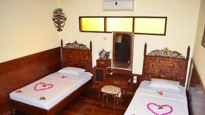 A hotel room with two wooden beds, a small desk, a chair, and a mirror. - Bagan Central Hotel (Nyaung-U)