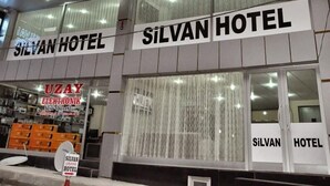 A hotel with a modern glass facade and signage for 'Silvan Hotel'. - Grand Silvan Otel (Silvan)