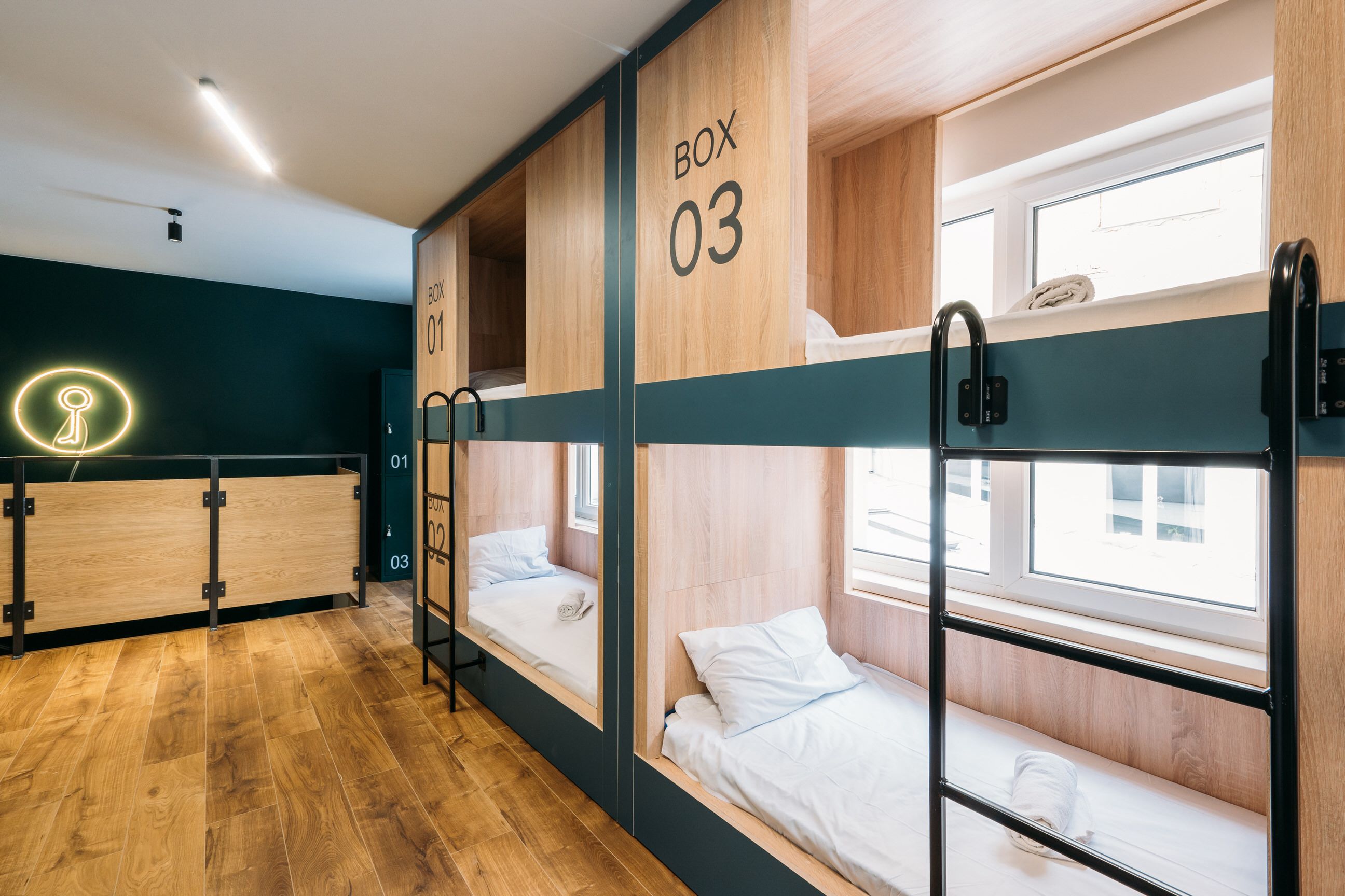 A bunk room with three wooden bunk beds, each labeled with a number.