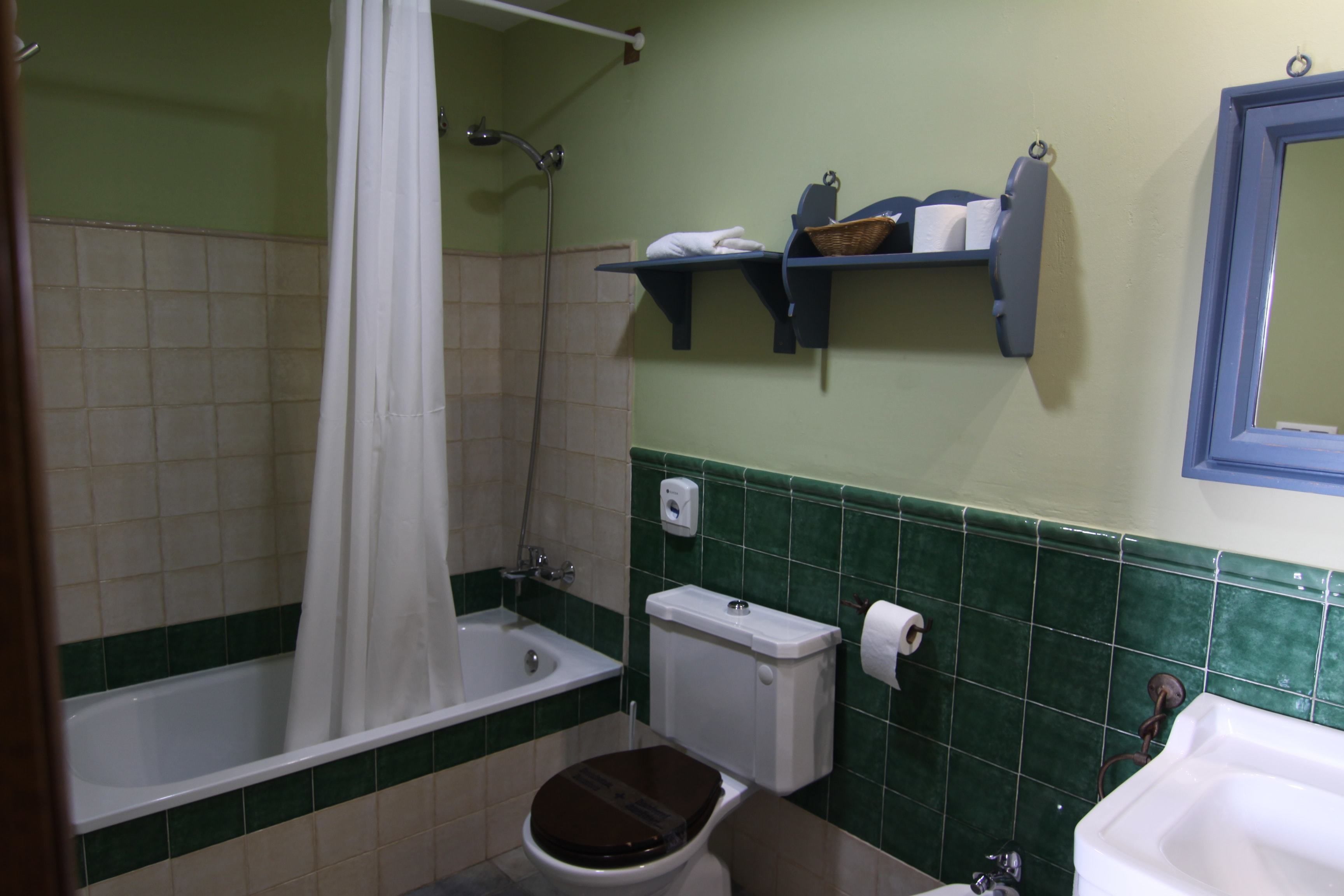 A bathroom with a bathtub, toilet, and sink.