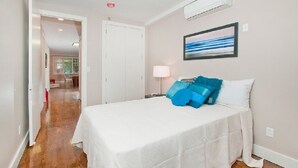 A hotel room with a bed, a nightstand, a lamp, and a painting on the wall. - Home for rent asap now is available to move in (Austin)