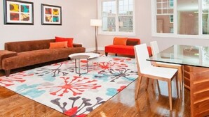 A modern living room with a sofa, a glass table, and a colorful rug. - Home for rent asap now is available to move in (Austin)