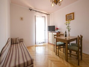 Apartamento, varias camas | Sala de estar | Una televisión