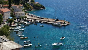 A coastal town with a marina, boats, and buildings along the waterfront. - Apartments Vesna Mimice (Omis)