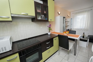 Enjoy cooking in the well-equipped kitchen with an oven and stovetop, perfect for preparing meals.