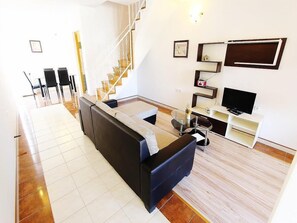 Apartment, Multiple Beds | Living room | TV
