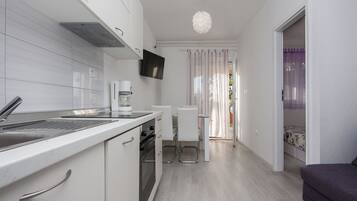 Apartment, Multiple Beds | Private kitchen | Microwave, stovetop, dishwasher, coffee/tea maker