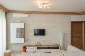 Apartment, Multiple Beds | Living room | TV