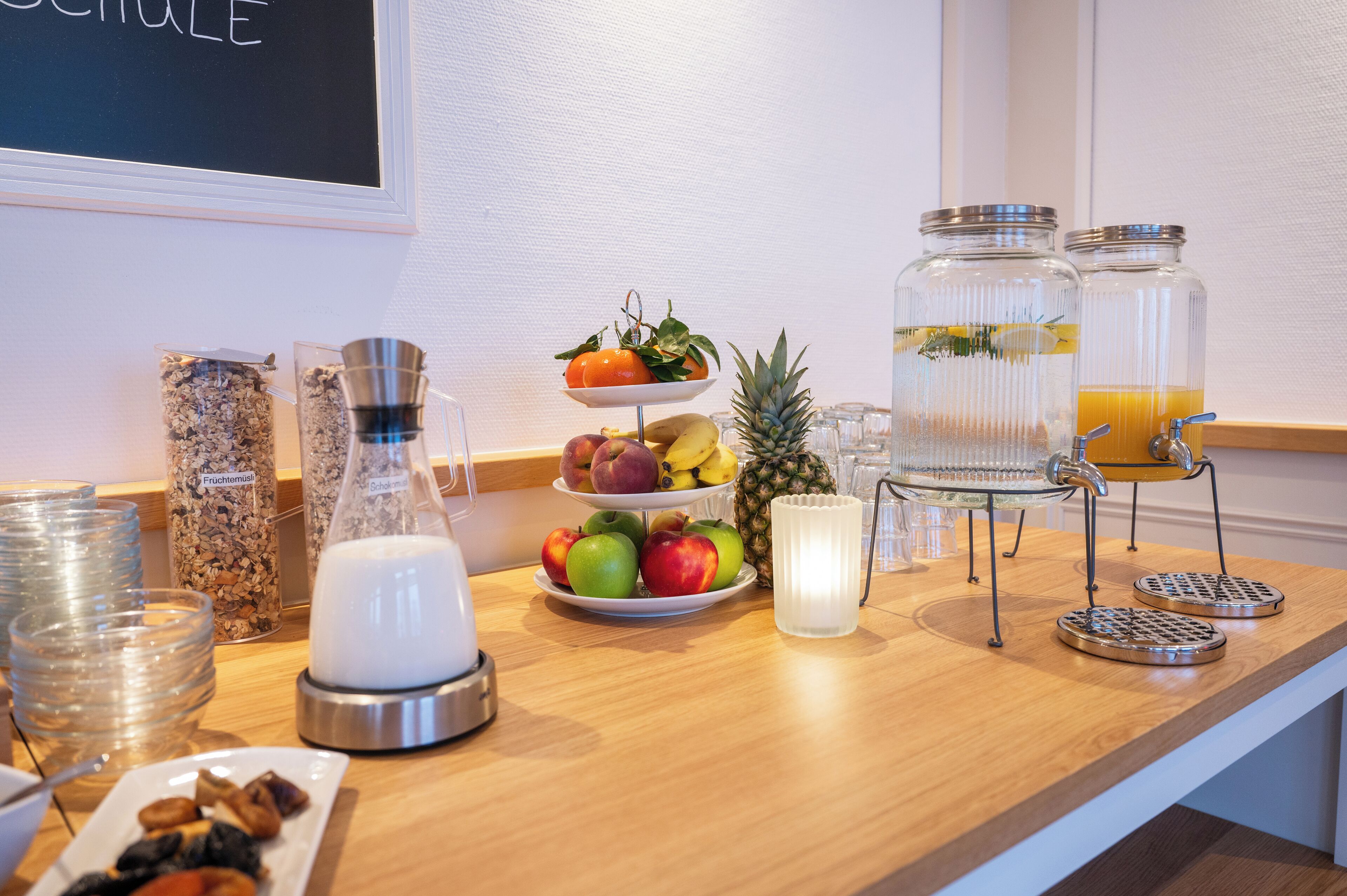 A breakfast buffet setup with various food items and beverages.