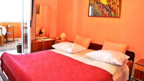 Une chambre d’hôtel avec un lit, un bureau et une chaise.
