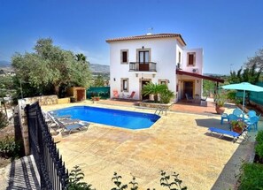A two-story house with a swimming pool, outdoor seating, and a view of the surrounding landscape. - Villa Christodoula (Polis)