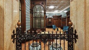 An ornate hallway with a high ceiling, detailed ceiling artwork, and a large arched doorway. - DoubleTree by Hilton Trieste (Trieste)