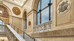 A grand staircase with ornate carvings and a skylight above. - DoubleTree by Hilton Trieste (Trieste)