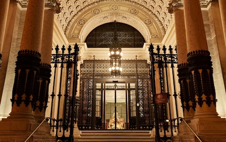 The entrance of the DoubleTree by Hilton hotel with ornate columns and a detailed ceiling.