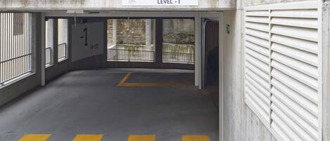 A parking garage with a sign indicating "PARKING RESERVED LEVEL -1".