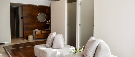 A modern living room with a sofa set, a coffee table, and a decorative vase.