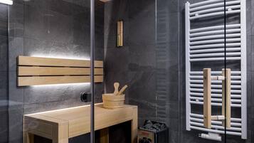 A modern bathroom with a wooden vanity, a glass shower enclosure, and a built-in towel rack.