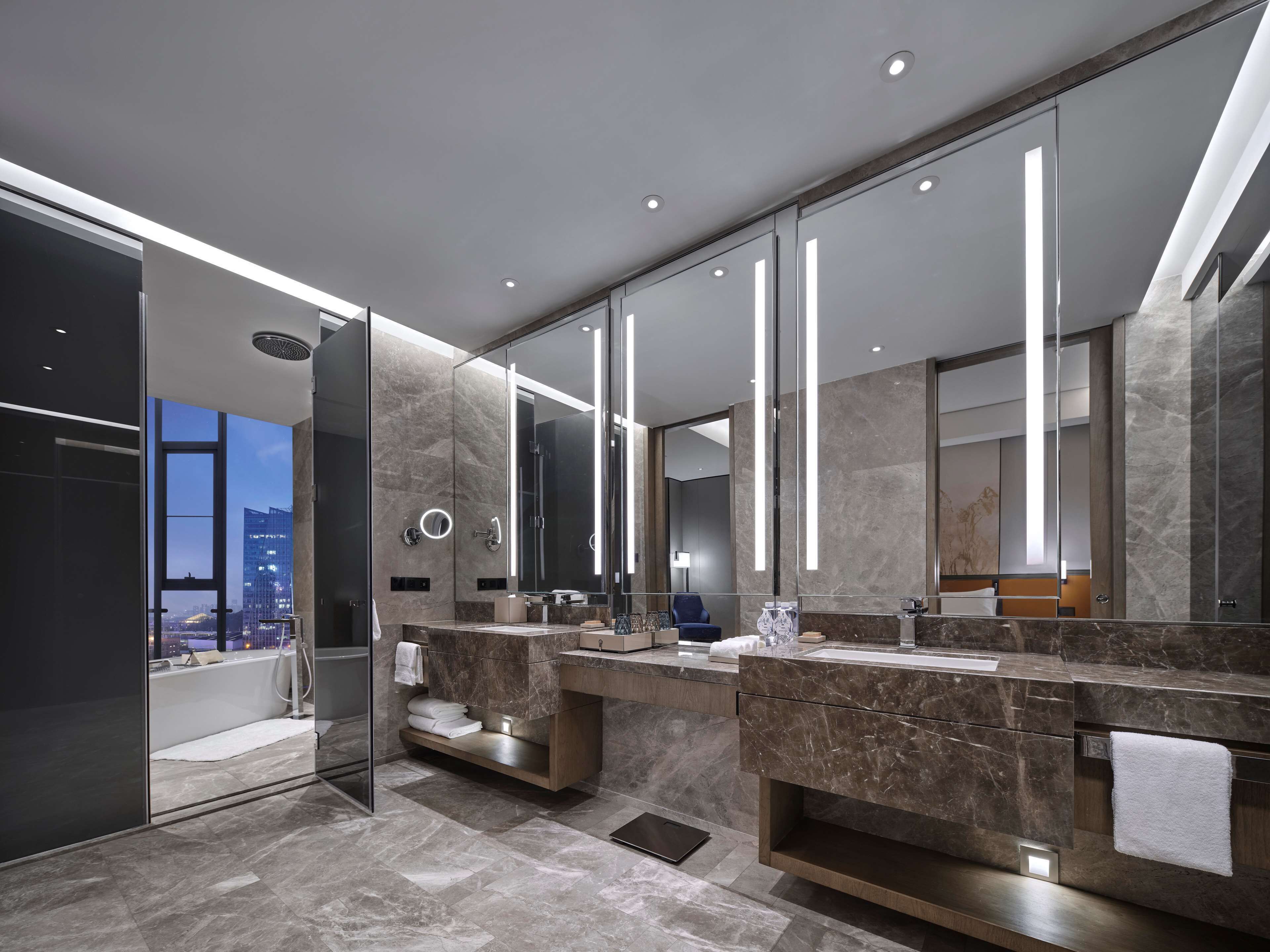 King One Bedroom Executive Suite | Bathroom | Designer toiletries, hair dryer, bathrobes, slippers