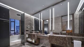 King One Bedroom Executive Suite | Bathroom | Designer toiletries, hair dryer, bathrobes, slippers