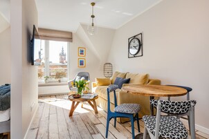 Apartamento de diseño, vistas a la ciudad | Zona de estar | Televisión de pantalla plana de 55 pulgadas con canales por cable