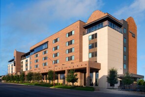 A multi-story hotel with a brick facade, large windows, and a sign indicating 'Springhill Suites'. - SpringHill Suites by Marriott Fort Worth Historic Stockyards (Fort Worth)