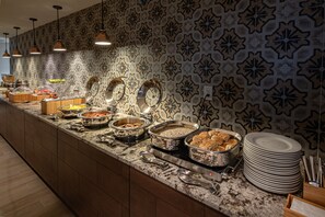 Enjoy a diverse selection of fresh fruits, vegetables, and prepared dishes at our buffet.