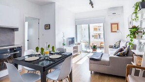 A modern living space with a dining area, kitchen, and a sofa set. - Marina's Flat Limassol (Limassol)