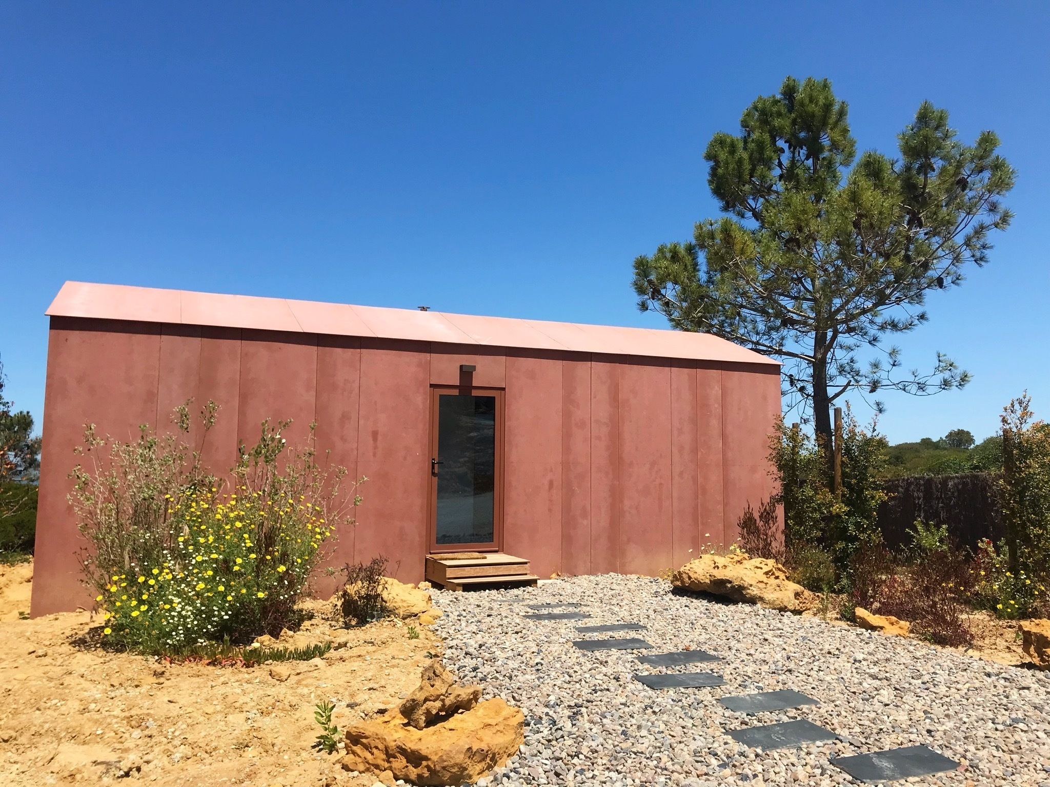 A small, single-story building with a flat roof and a door.