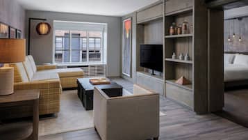 A modern living room with a sofa, coffee table, and a television.
