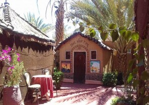 A small building with a thatched roof and a sign that reads "TAKE YOUR TIME". - Hostel Take Your Time 4231 (Zagora)