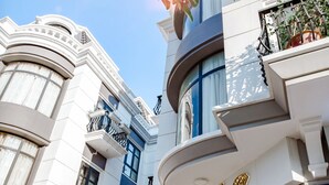 A building with a curved facade, balconies, and a sign that reads "Hotel". - The Oriental Ruby (Dong Hoi)