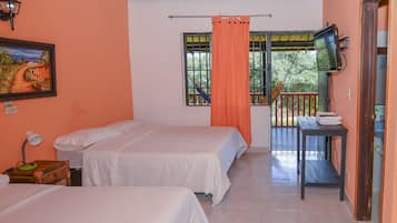 A room with two beds, a painting on the wall, a window with a view, and a television on a table.