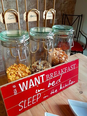 A breakfast bar with jars labeled 'Corn Flakes', 'Muesli', and 'Bran Flakes'. - Casa 44 (Alhaurin el Grande)
