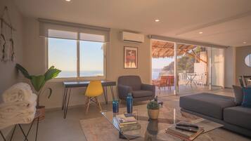 Deluxe Apartment, 3 Bedrooms, Sea View | Living area | 45-inch Smart TV with cable channels, TV, Netflix