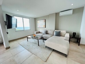 Deluxe Condo, 3 Bedrooms, Sea View | Living area | 45-inch Smart TV with cable channels, TV, Netflix