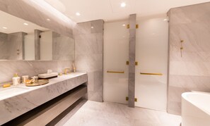 A modern bathroom with a marble vanity, a large mirror, and a walk-in shower with gold accents. - Luxury Sea View Apt in FIVE Resort on The Palm (Dubai)