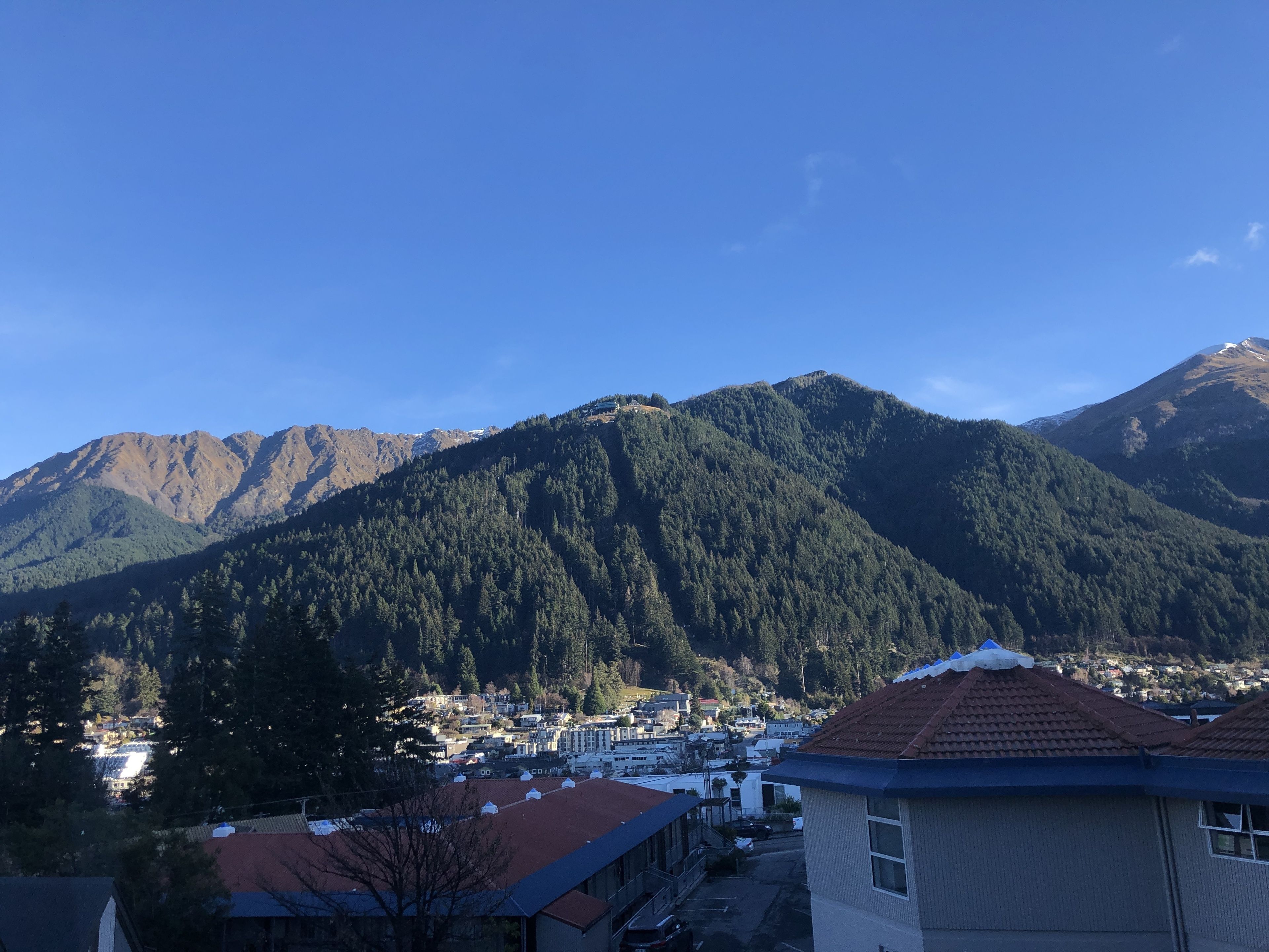 A mountain landscape with a town in the foreground.