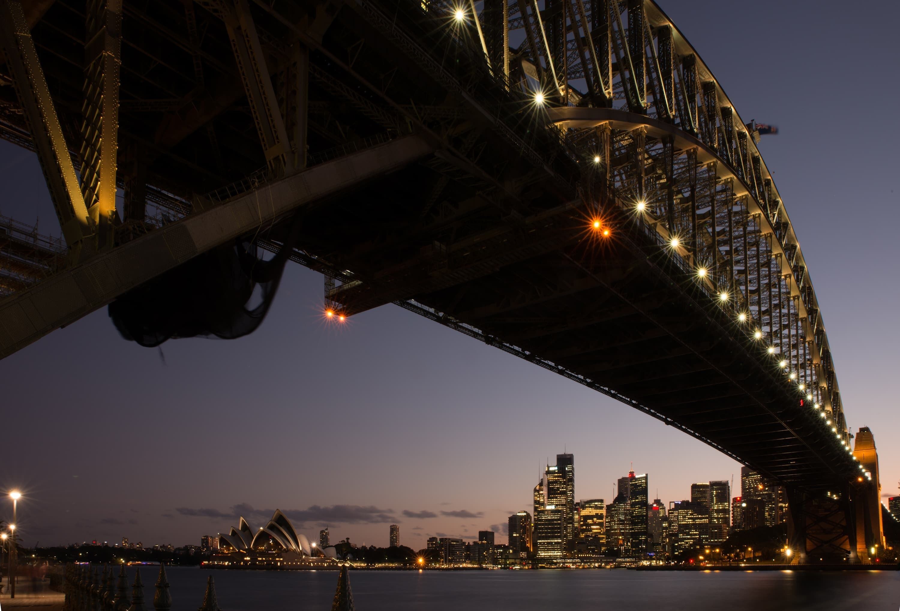 A bridge with a city skyline in the background.