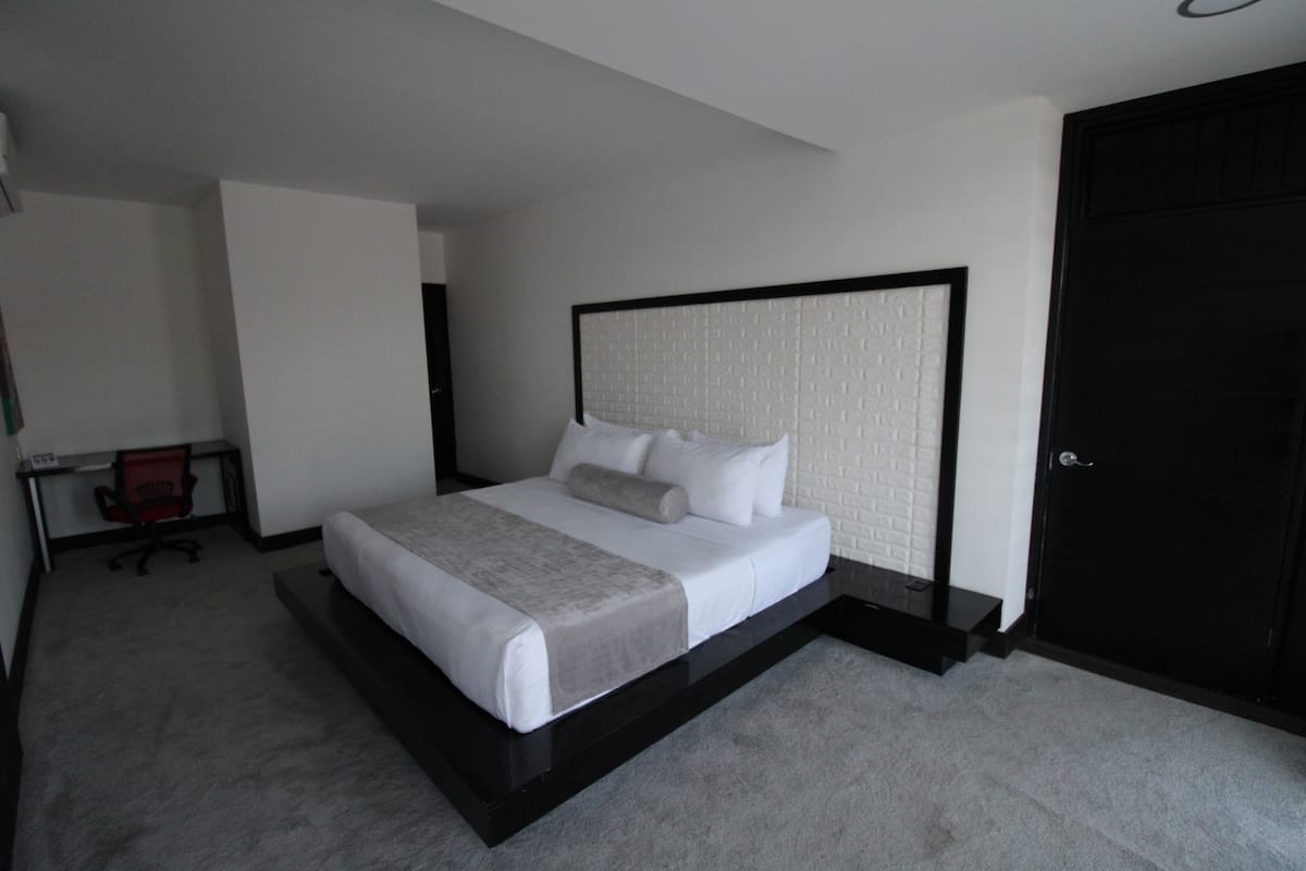 Luxury Room | Premium bedding, desk, laptop workspace, blackout curtains