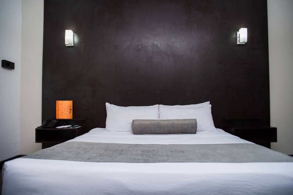 Premium bedding, desk, laptop workspace, blackout drapes