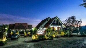 A building with a sign reading "NATURE LAND" at dusk.
