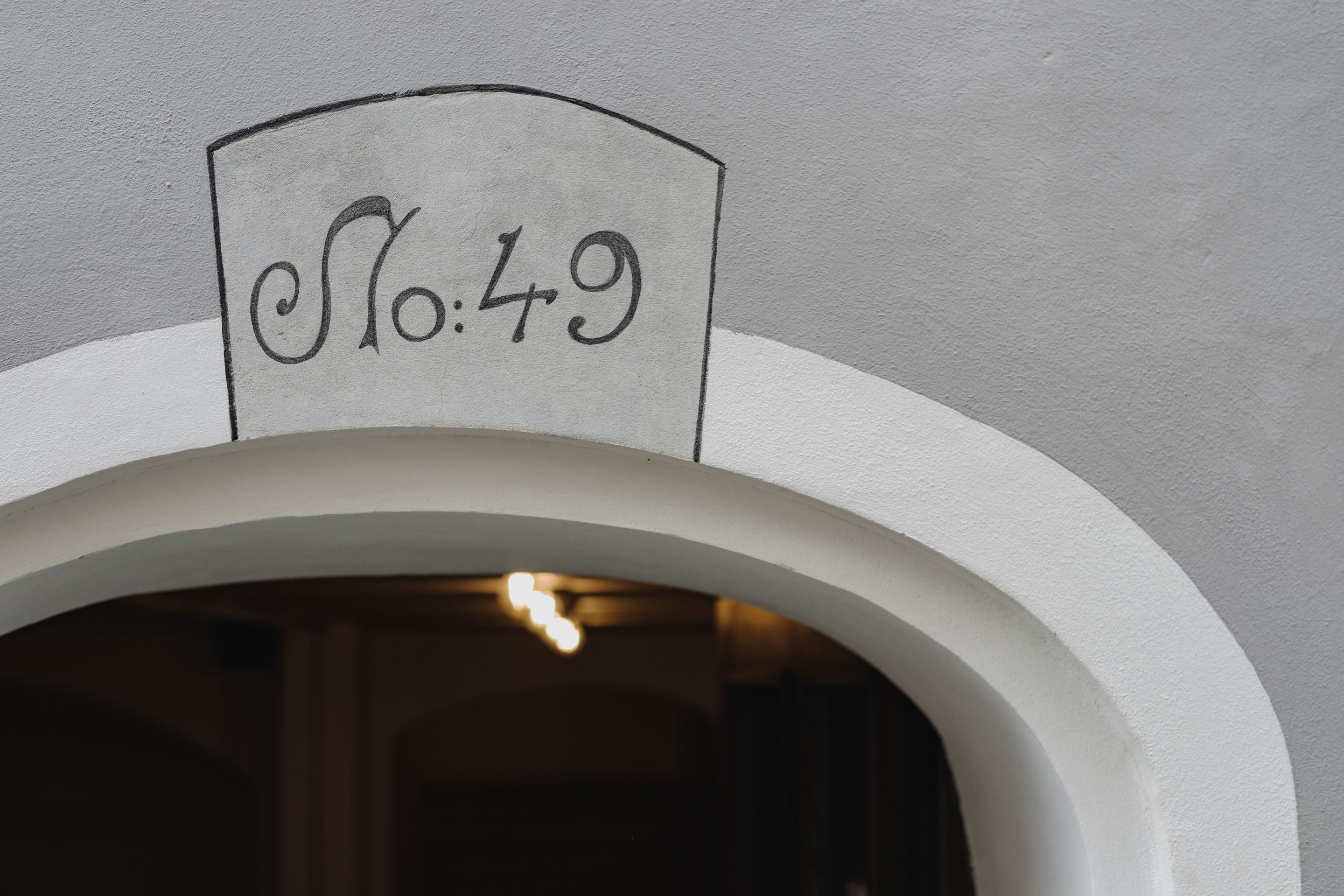 A doorway with a sign above it that reads "No.49".