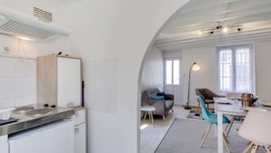 A modern kitchen with a built-in stove and a white refrigerator.
