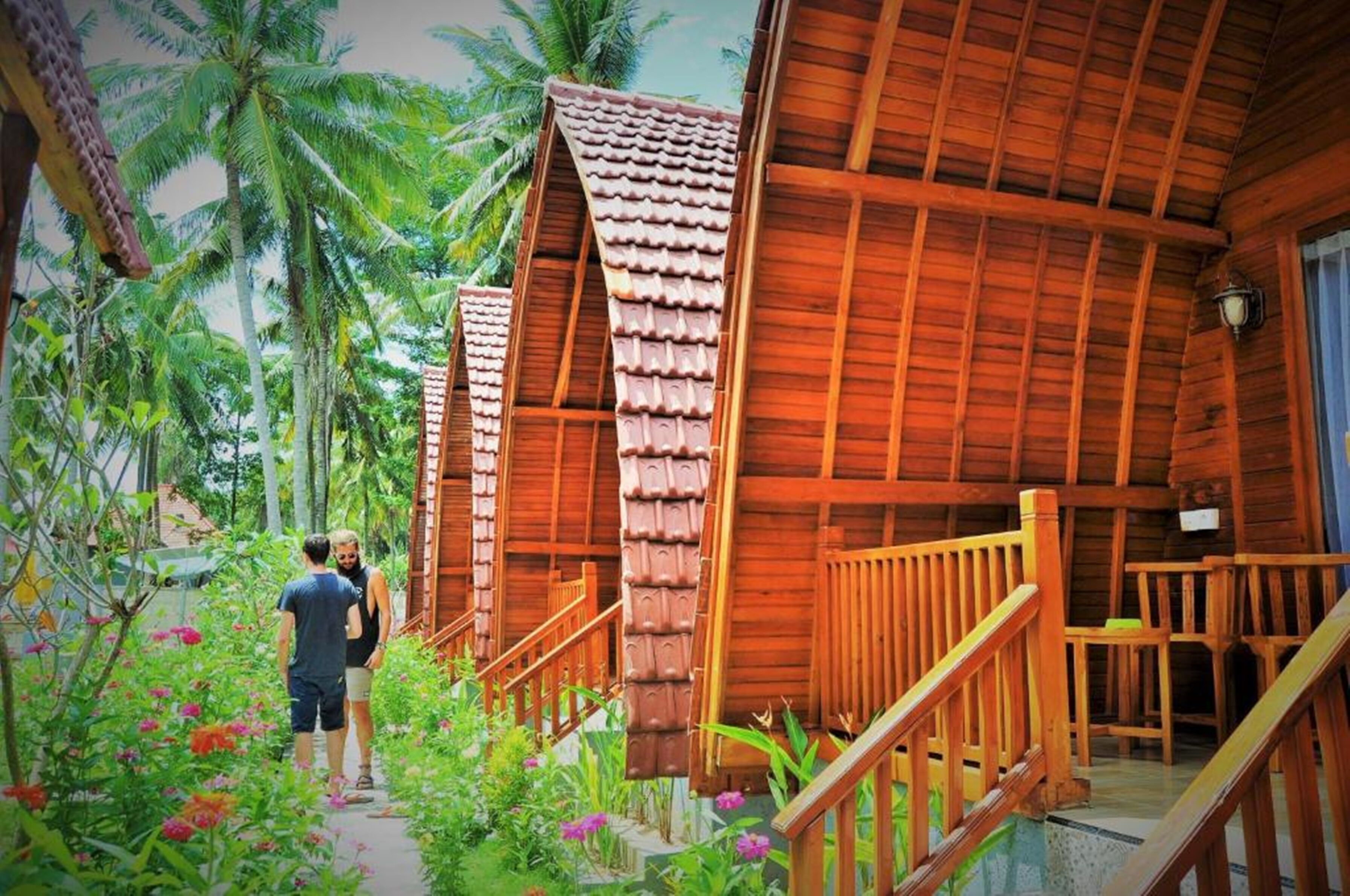 A wooden building with a sloped roof and a staircase leading to a covered porch.