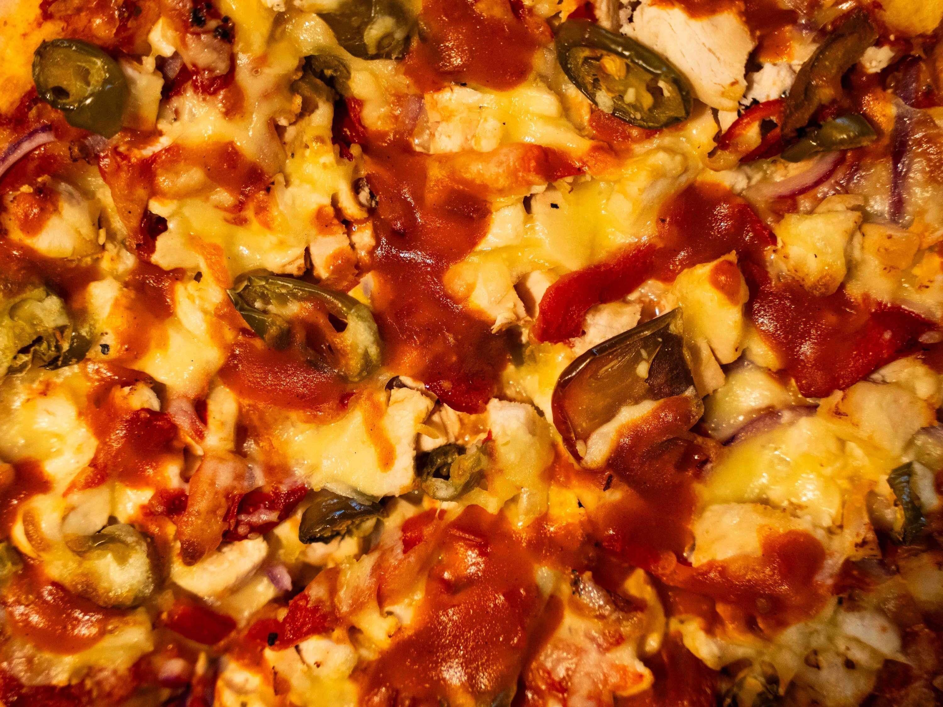 A close-up of a pizza with various toppings.