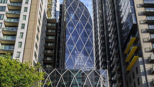A modern building with a glass facade and a geometric pattern.
