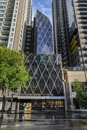 A modern building with a glass facade and a geometric pattern.