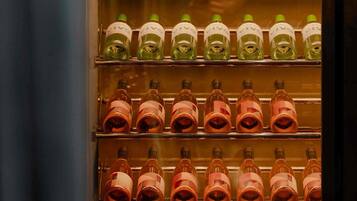 A refrigerated display case with multiple shelves containing bottles.