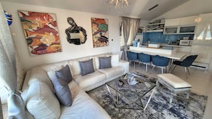 A modern living room with a sofa, coffee table, and artwork on the wall. - Apartment Sonja (Klimno - island Krk)